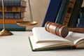 Wooden gavel, scales of justice and books on table Royalty Free Stock Photo