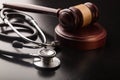 Wooden gavel and stethoscope close-up view