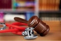 Wooden gavel and stethoscope, close-up view