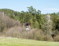 Wooden gazebo, altan or summer house on top of Sandstone rock pillar in spring landscape with fresh pine and spruce tree