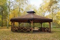 Wooden gazebo in autumn parks - relax and unwind