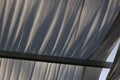 Wooden gazebo in the golden hour light, almost sunset: close up of white cloths, soft light, summer mood, vacation, holiday and