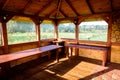 Wooden gazebo inside with tables