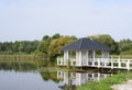 Wooden gazebo with pier on lake Royalty Free Stock Photo