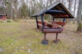 Wooden gazebo for relaxation. barbecue place. Iron grill near the gazebo. Royalty Free Stock Photo