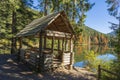 Wooden gazebo for relaxation near Lake Synevyr next to the autumn forest in the Carpathian mountains on a sunny autumn day. Royalty Free Stock Photo