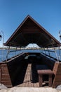 A wooden gazebo in the shape of a boat with a deck near the river Royalty Free Stock Photo