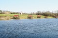 Wooden gazebos on the shore of the blue lake for tourists