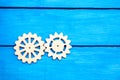 Wooden gears ,cogwheel, on a blue background, mechanism Royalty Free Stock Photo