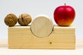 Wooden geometrical pieces with apples and walnuts