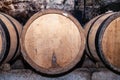 Wooden giant wine oak barrels stacked in rows. Aging, fermentation, store in old wine cellar. Concept sommelier trip