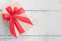 Wooden gift box with red ribbon bow on vintage background Royalty Free Stock Photo