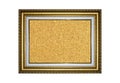 Wooden and gold gilded ornamental frame with rectangular beige cork board Royalty Free Stock Photo