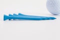Wooden golf tees and golf ball on the white table Royalty Free Stock Photo