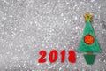 Wooden Green Christmas tree, sign 2018 from wooden red letters, gray concrete background. Happy new year 2018 backdrop. Greeting