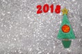 Wooden Green Christmas tree and sign 2018 from wooden redletters, gray concrete background. Happy new year 2018 backdrop.