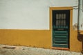 Wooden green door in an old building facade with colorful wall Royalty Free Stock Photo