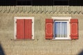 wooden green facade with red color shutter of bavarian farmhouse