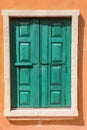 Wooden green window in old orange colonial. Royalty Free Stock Photo