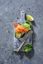 Whole grain bread sandwiches with fresh cucumber, spinach leaves, avocado and smoked salmon