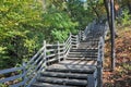 Wooden grey strong old stair in Namsam Mountain hiking trail park in Autumn forest afternoon Royalty Free Stock Photo