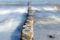 Wooden groynes as coast protection in the sea on a sunny day, sm