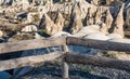 Wooden guardrail at the with background of vocanic rocks and cave hotel in Goremen, cappadocia, Turkey Royalty Free Stock Photo