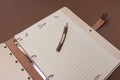 Wooden guests book with pen on brown colored paper background. close up Royalty Free Stock Photo