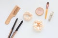 Wooden Hairbrush, hair straightener and yellow silk Scrunchy isolated on white. Flat lay Hairdressing tools and accessoriesas Royalty Free Stock Photo