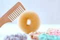 Wooden hairbrush and Lot of Colorful silk Scrunchies on white. Luxury Hairdressing tools and accessories. Hair Scrunchies, Elastic Royalty Free Stock Photo