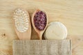 Wooden hairbrush, spoon with aroma bath salts or foot soak, soap bar and loofah sponge. Natural beauty treatment Royalty Free Stock Photo