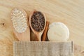 Wooden hairbrush, spoon with coffee and sugar scrub bath salts, foot soak, soap bar and loofah sponge. Natural beauty treatment Royalty Free Stock Photo