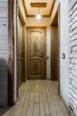 Wooden Hallway Interior with Closed Doors and Warm Lighting Royalty Free Stock Photo