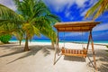 Wooden hammok and palms with tropical lagoon Royalty Free Stock Photo