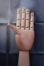 Wooden hand with five fingers raised and numbered with numbers one, two, three, four and five Royalty Free Stock Photo