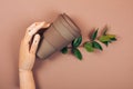 Wooden hand holding reusable cup of coffee