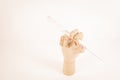 Wooden hand holding a white paintbrush on white background Royalty Free Stock Photo