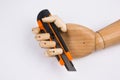 Wooden hand with office cutting knife