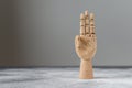 The wooden hand shows three raised fingers. The concept of communication Royalty Free Stock Photo