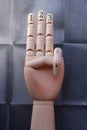 Wooden hand with three fingers raised and numbered with numbers one, two and three Royalty Free Stock Photo