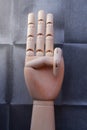 Wooden hand with three raised fingers Royalty Free Stock Photo