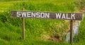 Wooden handmade sign in summer forest, park in Canada. Swenson Walk Park in British Columbia