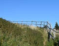 Wooden handrail along an unmaintained hiking path Royalty Free Stock Photo