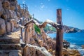 Wooden handrail of a stone path by the sea in Costa Paradiso Royalty Free Stock Photo