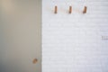 wooden hanger hook on white brick wall Royalty Free Stock Photo