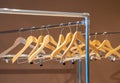 Wooden hangers on coat rack with no clothes in wardrobe Royalty Free Stock Photo