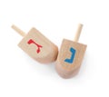 Wooden Hanukkah traditional dreidels with letters Gimel and Nun on white background, top view Royalty Free Stock Photo