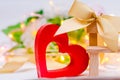 Wooden heart with a bow on a bench on a white background. Valentine`s Day. concept of love, romantic decor.