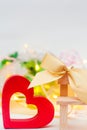 Wooden heart with a bow on a bench on a white background. Valentine`s Day. concept love. romantic elegance