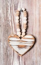 Wooden heart hanging on a rustic plank